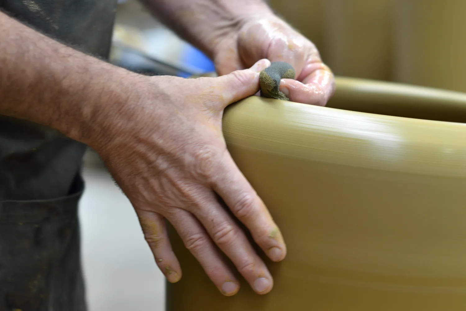 Skilled hands shaping a Morris & James pot