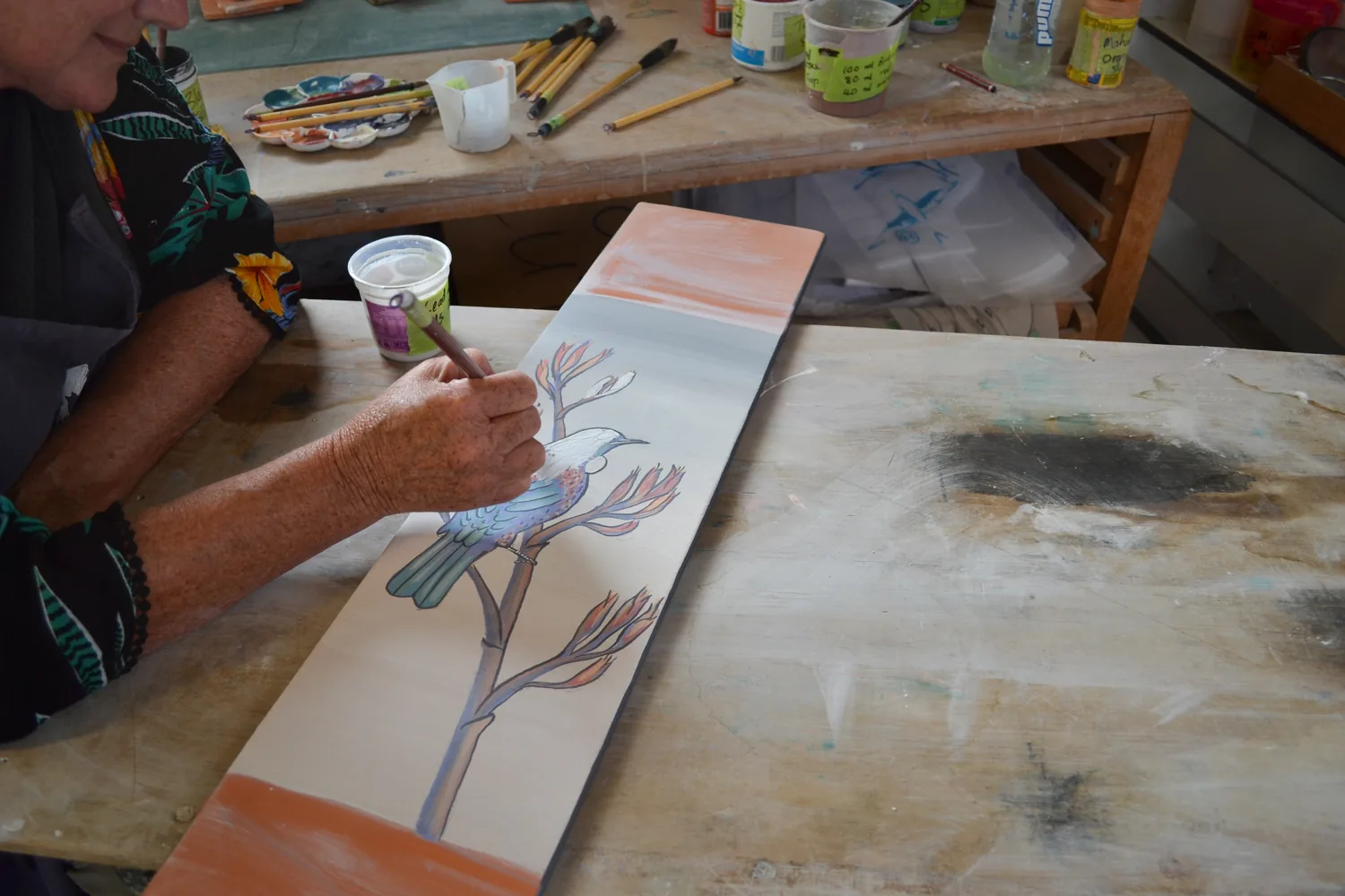 Working clay at the bench in the workshop