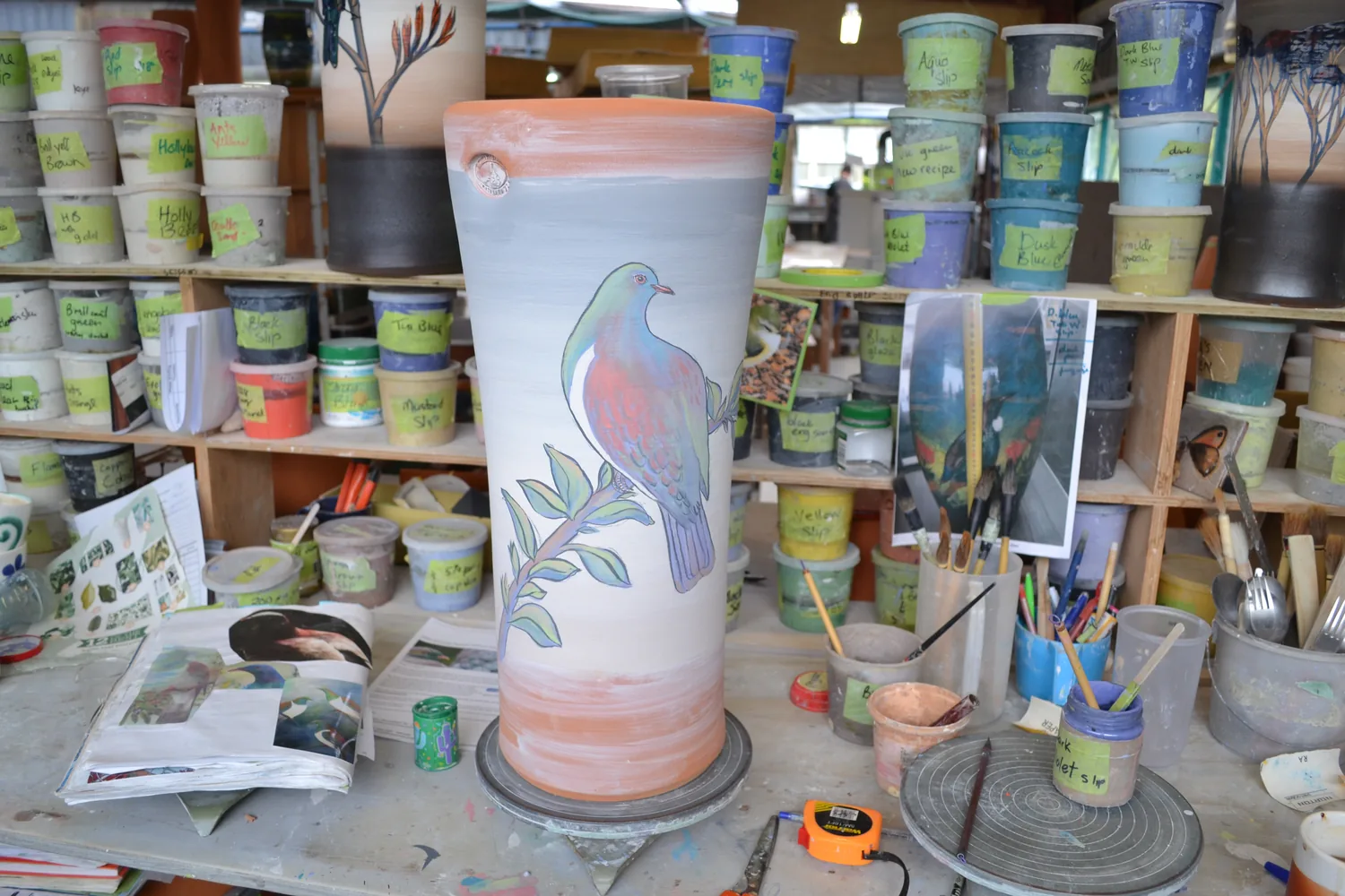 A hand-painted glazed pot on display