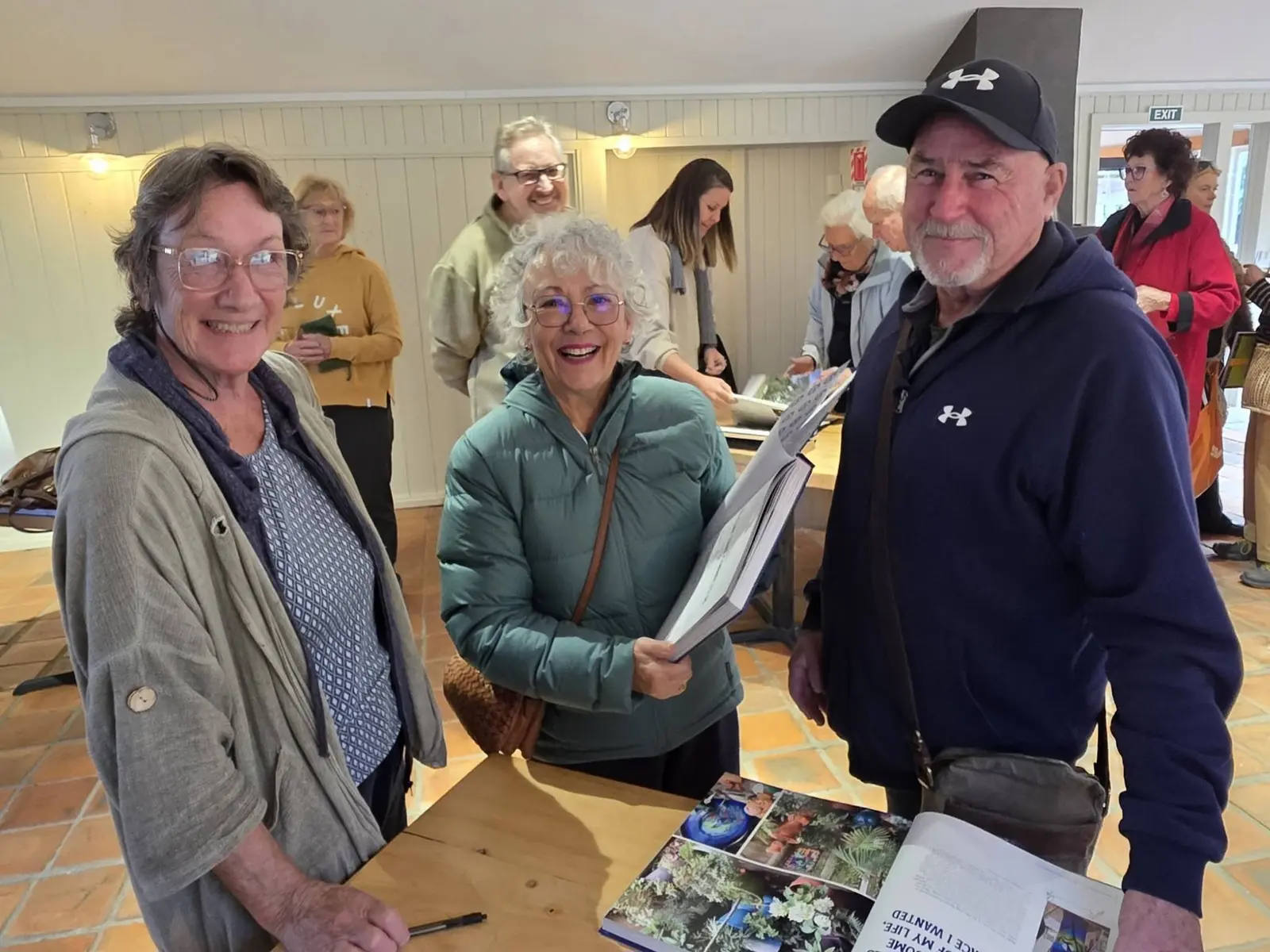 Guests smiling with their copies of the book