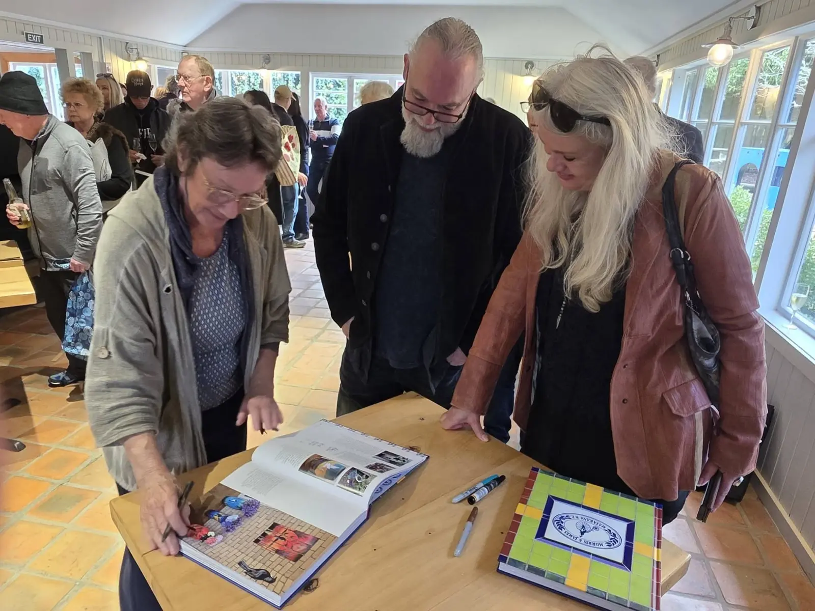 Guests poring over the book's pages together